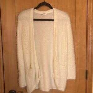 Fuzzy cardigan will fit anyone from size xs,s, and m.